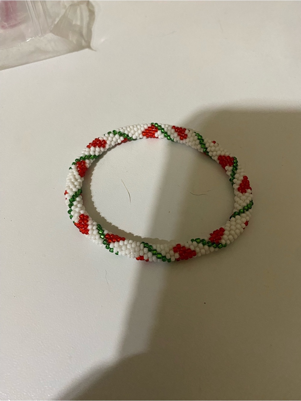 White Beaded Bracelet with Red and Green Accents